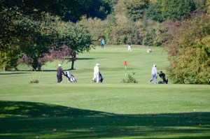 A photo of golfers walking their caddies between holes at Chingford Golf Course